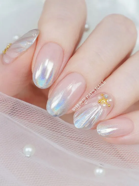 This photo showcases a unique take on mermaid nails ideas, using a sheer, iridescent polish that gives a luminous and elegant mother-of-pearl effect.